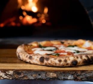 pizza on brown wooden table